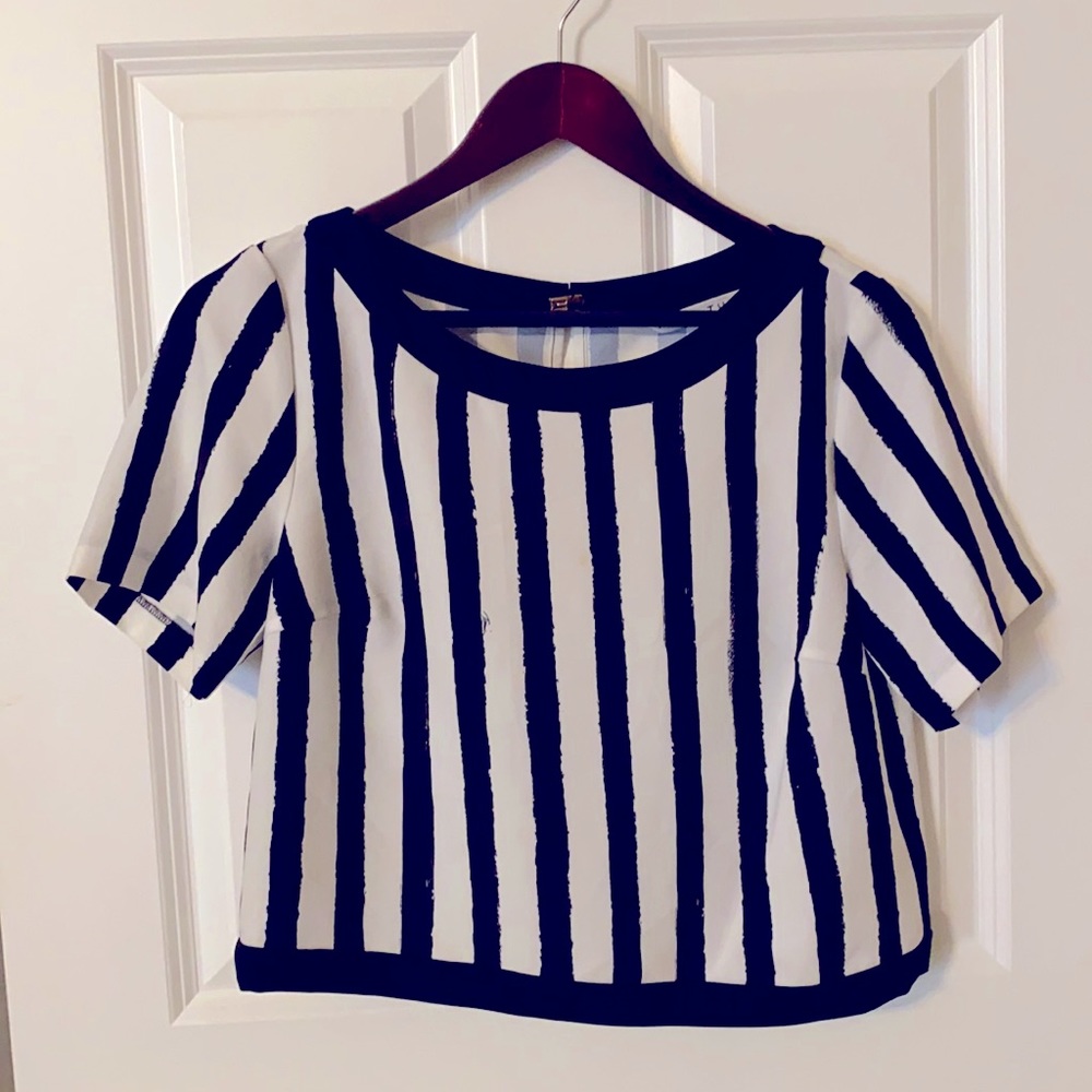 Trina Turk short sleeve Black & White Striped cropped top w/ gold clasp closure.